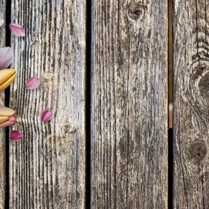 Pink and yellow tulip bouquet on rustic wooden background with soft natural lighting, horizontal floral flat lay