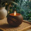 Tropical coconut candle holder with warm glowing flame on wooden tray, eco-friendly home decor surrounded by lush green jungle background and soft ambient lights